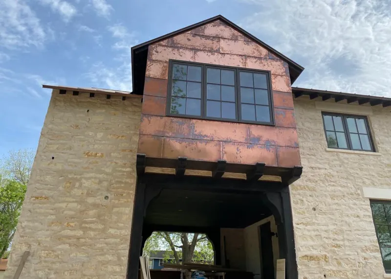Copper metal panel facade on a stone building for Skylight Installation in Streamwood