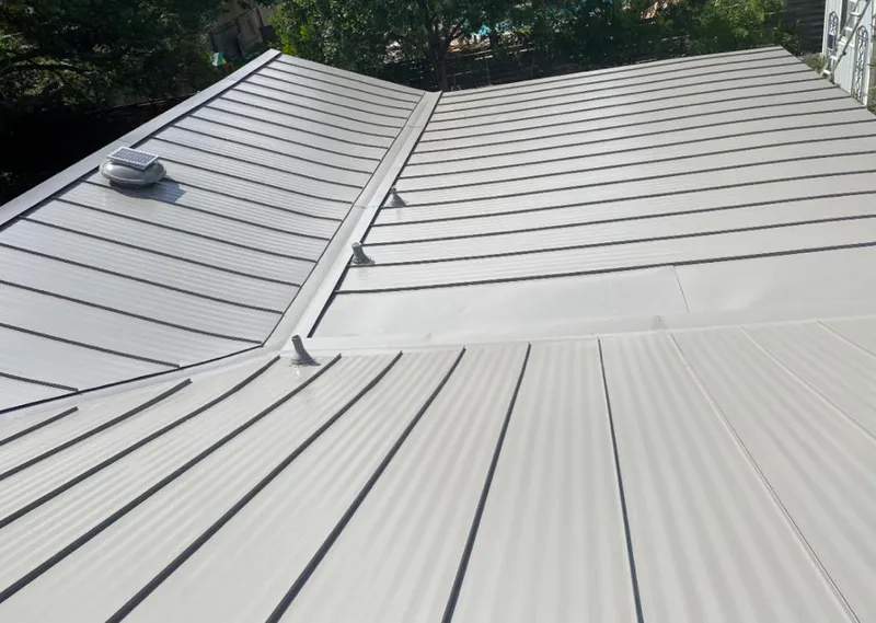 Solar attic fan installed on a metal roof for Roof Ventilation in Streamwood